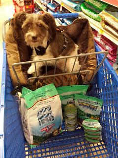 Image of Pixel Blue Eyes in a shopping cart filled with Natural Balance dog food items